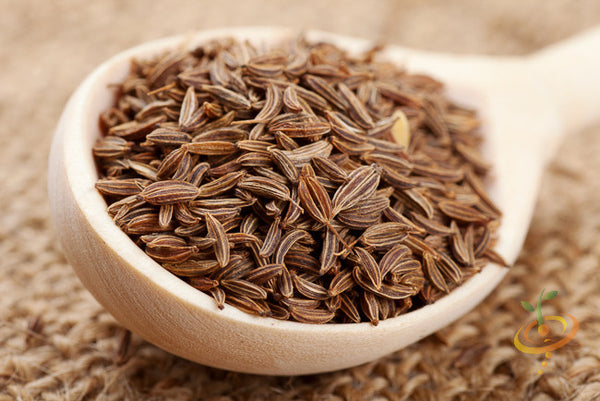 Close-up of organic Caraway seeds from SeedsNow, showing small brown cumin-like seeds in a clear glass jar.