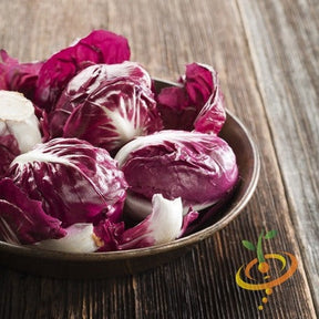 Bowl of classic red radicchio with white veins on a wooden surface